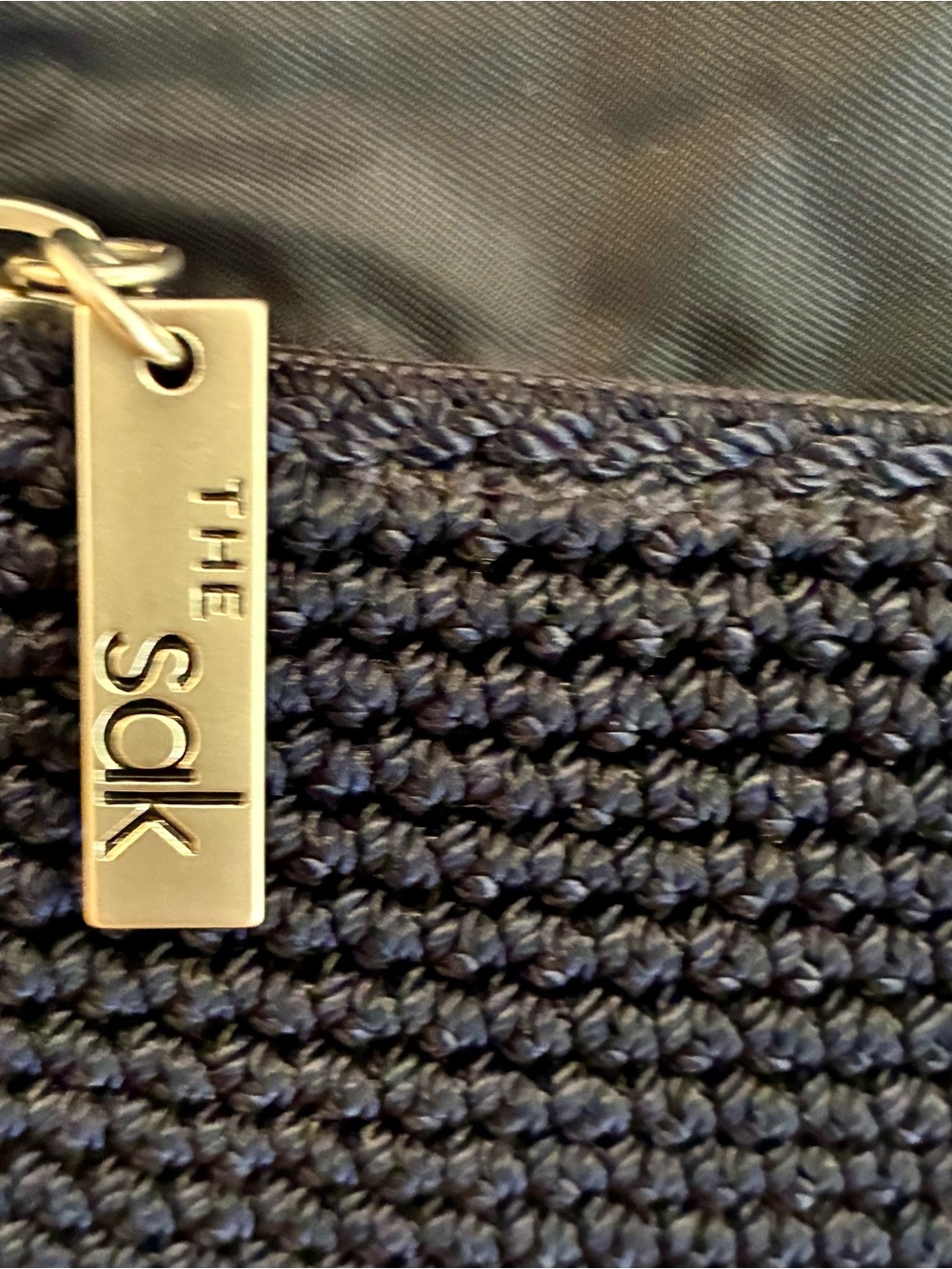 The Sak Navy Woven Crossbody Bag with Silver Accent. (Appears Gold, its Silver)